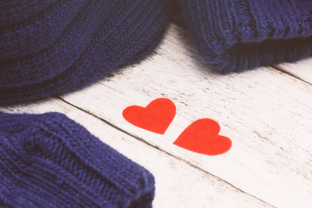 Valentines day concept. Two red hearts and knitted sweater. Toned photoの写真素材