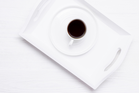 White cup of black coffee on a white wooden background. Top view, copy spaceの写真素材
