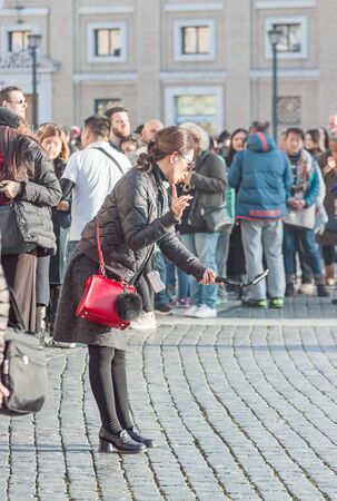 Vatican, 21 January, 2017. Young women makes selfie on the squareのeditorial素材
