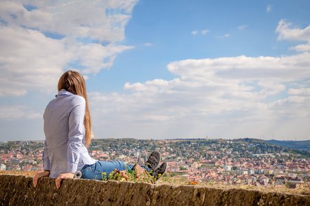 Young woman looking at Wurzburg panorama, Germanyの写真素材