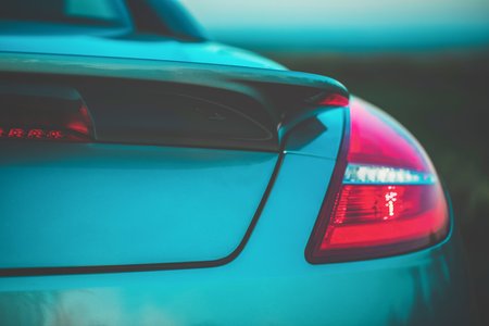Fashionable sports turquoise car. Fragment automobile, details. Evening light, toned photo. Copy spaceの写真素材