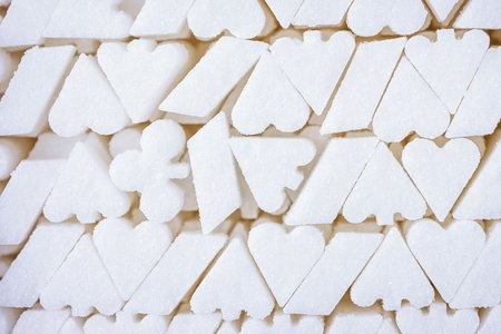 White sugar background. Shape of the playing card suit symbol. Addiction of sweets like a gambling addiction.の写真素材