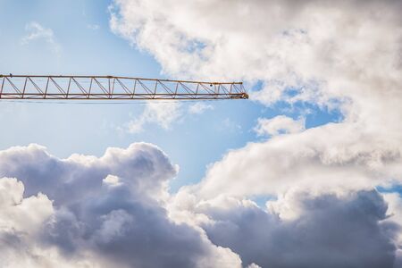 Crane and beautiful cloudy sky. Details, fragment, White and gray clouds. Incredible sky with cloudsの写真素材