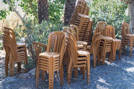 Stock of brown plastic chairs for pilgrims on nature background. Tabgha Israelの写真素材