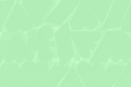 Trendy neo mint color background. Abstract light green gradient background with card suit symbol patternの写真素材