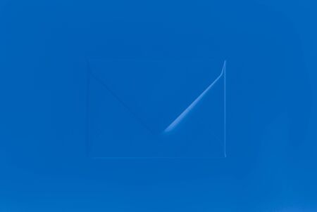 Deep blue color envelope on blue background, minimal conceptの写真素材