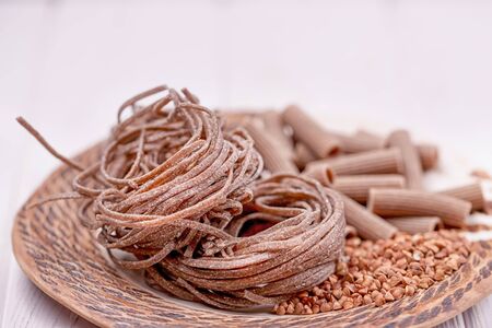 Brown raw buckwheat pasta, noodles and buckwheat groats, copy spaceの写真素材
