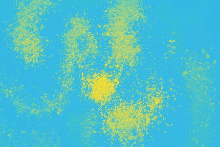 Blue background with yellow powder spots. Abstract backgroundの写真素材