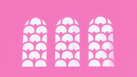 Three arched windows with pattern. Pink color, 16 on 9 panoramic formatの写真素材