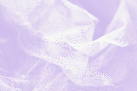White lace lingerie, pale violet gradient background. Flowing fabricの写真素材