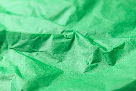 Crumpled vivid green paper abstract texture backgroundの写真素材
