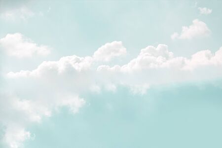 Pale soft mint color sky with delicate white clouds