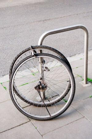 Bike wheels with padlock. Theft of a bicycle. Bicycles stolen and left only wheels. Bicycle theft crimes conceptの写真素材