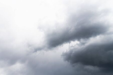 Dramatic gray clouds in the pale sky. Beautiful gray and white cloudy rainy sky