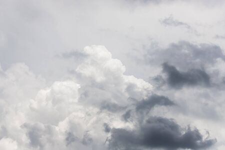 Dramatic gray clouds in the pale gray sky, beautiful sky background