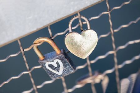 Two old rusty padlocks with heart on the bridge, copy spaceの写真素材