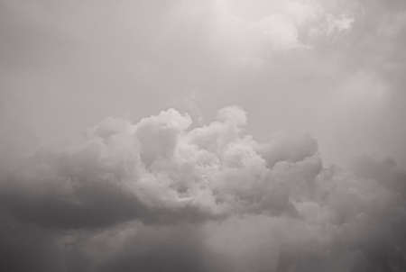 Gray fluffy clouds in the pale sky. Beautiful sky