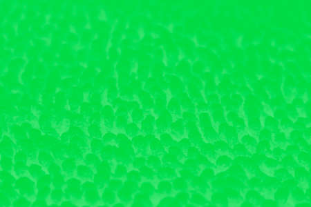 Vivid green blurred abstract patchy background with light spots
