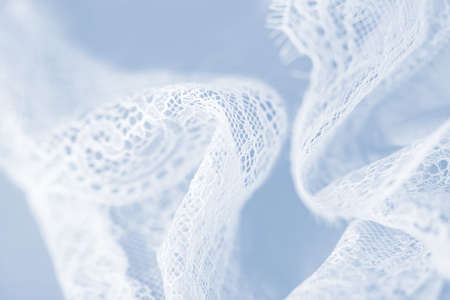Delicate white silk lace lingerie, light blue backgroundの写真素材