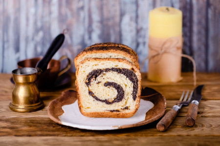 Homemade poppy seed and walnuts roll on a wooden backgroundの写真素材