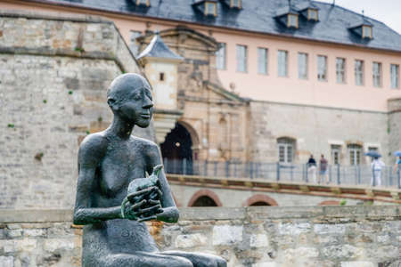 July 2021, Erfurt Germany, Man with an animal, a new sculpture in Erfurt in the rain