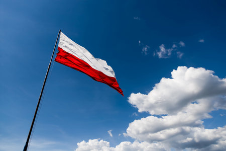 The flag of Poland flutters in the windの写真素材