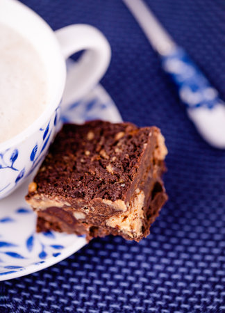 Coffee cappuccino and a piece of brownie with peanut butterの写真素材