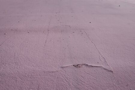 Cement wall with roughness, cracks and bumps. Abstract grunge background.の写真素材