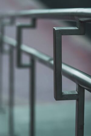 Stainless steel handrails on the street receding into the distance with selective focus. Beautiful...