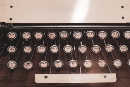 Keys of an old vintage american typewriter with russian and english alphabet closeup. Place for text.の写真素材