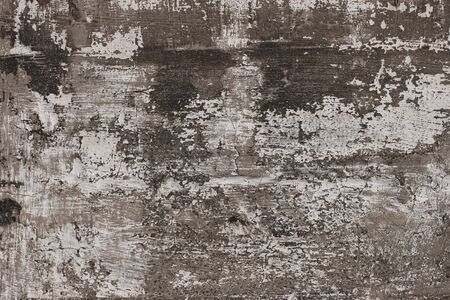 Abstract grunge background. Concrete wall with scratches, cracks and paint residues. Scuffs, holes and color tints.の写真素材