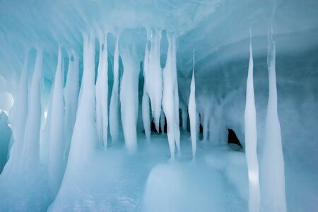 Beautiful smooth icicles with a green tint. Winter texture for background.