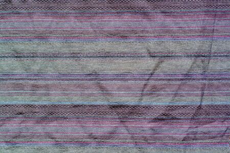 Fabric texture with horizontal stitches. Multi-colored stripes.
