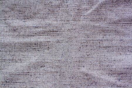 Gray fabric texture with textured stitches. Bulges and bumps in textiles.