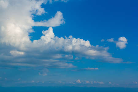 Cumulus clouds against a blue sky. Horizontal image.
