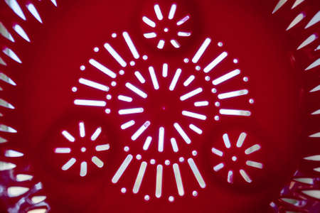 Pattern of holes in plastic colander. horizontal photo.の写真素材