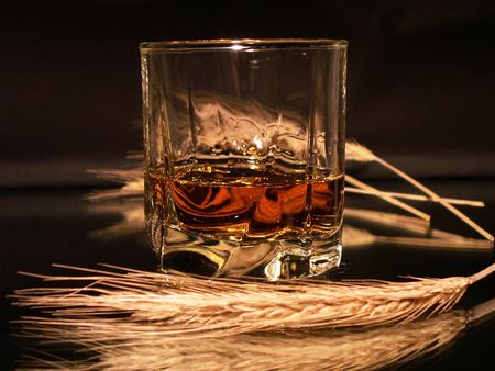 Class of whisky and wheat ears on dark backgroundの写真素材