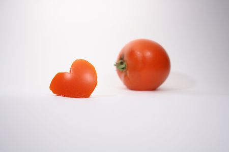 Tomato heart and tomato on white backgroundの写真素材