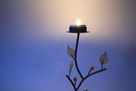 Nice candlestick as tree on multicoloured backround with lighting effectsの写真素材