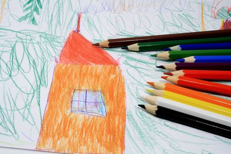 Sheet of paper with child's picture and lot of coloured pencilsの写真素材