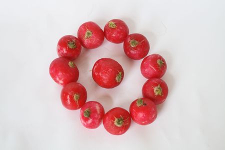 Ring made from fresh red garden radishes on white backgroundの写真素材