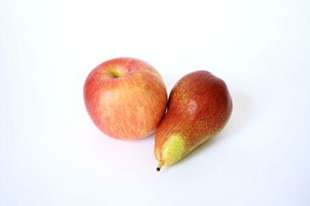 Ripe red apple and green pear lying on white backgroundの写真素材