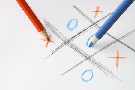 Red and blue pencils standing on white background with pictured ouths and crossesの写真素材