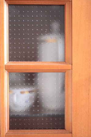 Close-up of glass dresser with dishwareの写真素材