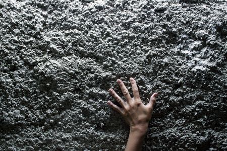 Nice female hand lying on gray stone backgroundの写真素材