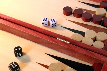 Opened backgammon board with dice and dibs