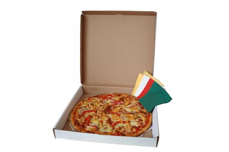Fresh pizza lying in pasteboard box with colored tissue paperの写真素材