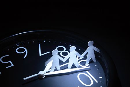 Three papery men standing on dark background with round clock