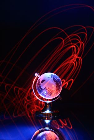 Dark background with glassy globe and round red linesの写真素材