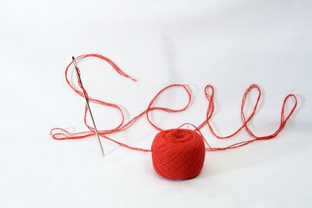 Inscription sew made from red thread and needle on white backgroundの写真素材